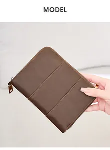 Detail of dark brown crazy horse leather passport holder with RFID protection and dual stitching
