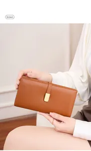 Detailed view of brown leather slim wallet with secure gold buckle clasp for cards