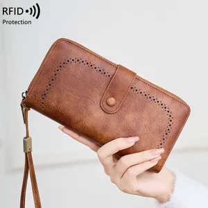 Brown vintage long RFID blocking wallet for women with cutout details and wrist strap