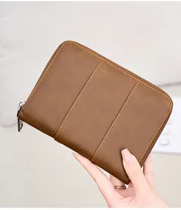 Close-up of vintage brown leather RFID passport holder with durable metal zipper detail