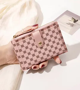 Detail of pink slim wallet showing clover texture, card slots and gold snap closure