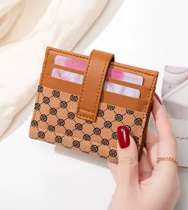 Close-up of brown patterned slim wallet showing multiple card slots and leather texture