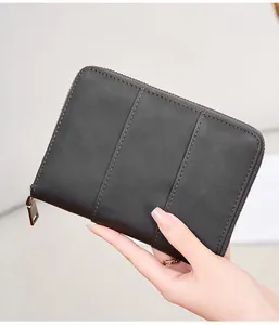Close-up of grey leather RFID passport wallet featuring vertical stitching and a metal zipper