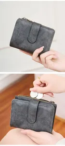 Close-up of a vintage grey RFID wallet showing the leather texture and coin compartment