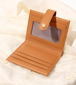 Detail view of the brown leather wallet interior showing ID window and card slots
