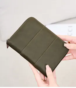 Detail of dark green crazy horse leather passport holder with high-quality triple stitching
