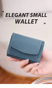 Close-up of Morandi blue-green textured leather compact wallet held by hand