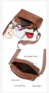 Detail view of the vintage brown crossbody bag interior with multi-layer zipper pockets