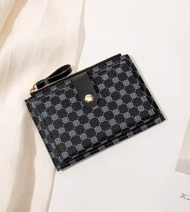 Close-up of slim women's wallet with blue clover pattern and metal zipper detail