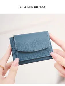Macro shot of blue lychee grain leather wallet with flip-top cover and fine stitching