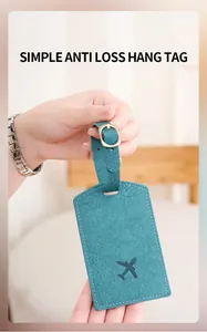 Detail of teal faux leather luggage tag showing pebble texture and embossed airplane icon