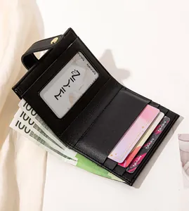 Detail of black leather wallet interior showing card slots and transparent ID window