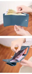 Detail view of the gray-blue litchi leather wallet's internal bill and card slots