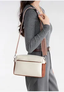 Detail of soft leather crossbody bag with geometric strap and contrast color design