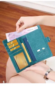 Detail of teal travel wallet with RFID protection, showing card slots and passport holder