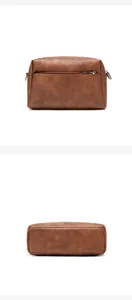 Detail of caramel brown leather bag showing back zipper pocket and textured finish