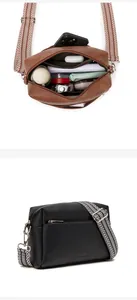Detail view of large interior storage and textured leather of the vintage square crossbody bag