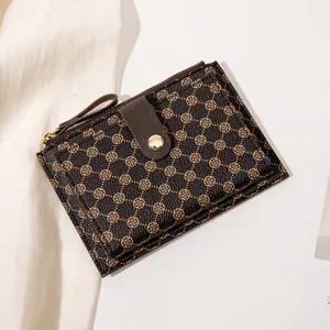 Slim dark brown women's wallet with gold floral print and textured leather finish