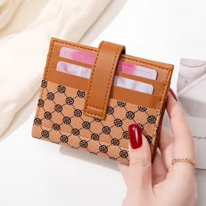 Women's slim bifold wallet in brown PU leather with black floral pattern and card slots