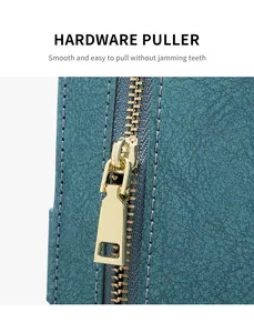 Detail of smooth metal hardware puller on a dark cyan RFID blocking passport wallet