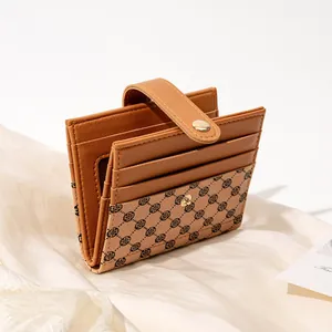 Caramel brown bi-fold short wallet for women featuring clover prints and button closure