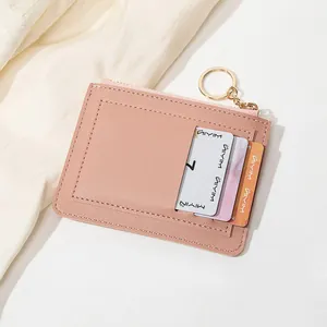 Détail du portefeuille mince en cuir PU rose avec fermeture éclair et porte-clés doré