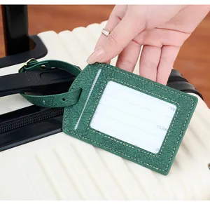 Green PU leather luggage tag with lychee texture attached to a cream suitcase