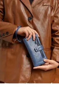 Deep blue long wallet with lychee texture held by a model in a retro style outfit