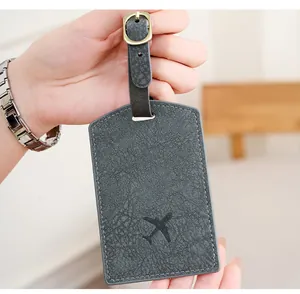 Close-up of dark grey PU leather luggage tag featuring a minimalist airplane icon
