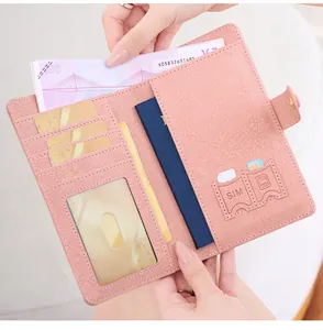 Pink leather RFID travel wallet detail with multiple card slots and passport compartment