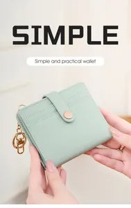 Detail of light green leather RFID wallet featuring neat stitching and a gold metal lobster clasp