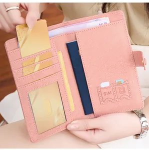 Detail view of pink RFID passport wallet showing multi-card slots and SIM holders