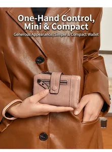 Compact pale pink PU leather wallet for women with zipper pocket held by model