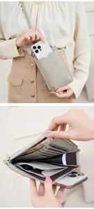 Macro view of grey litchi grain leather crossbody bag showing internal multi-card slots