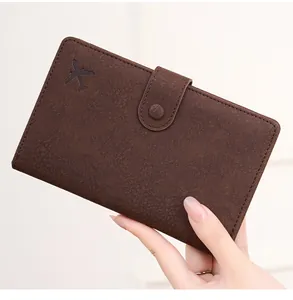 Detailed close-up of dark brown vintage passport holder with embossed airplane logo