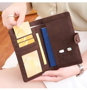 Detail of dark brown leather passport holder interior with card slots and SIM compartments
