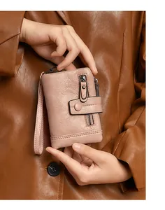 Close-up of pink RFID wallet featuring lychee texture and secure metal zipper detail