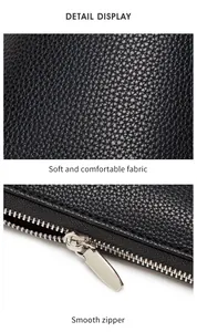 Detailed view of black litchi pattern leather texture and smooth silver zipper hardware