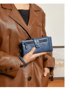 Detail view of a blue soft leather RFID wallet with double zippers and snap buckle closure