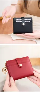 Slim RFID-blocking bifold wallet in black and red pebble leather with a gold keychain