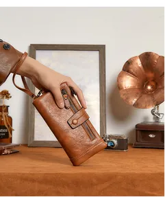 Detail of vintage brown leather long wallet with zipper and snap closure with wristlet