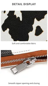 Detalle de la cartera con estampado de vaca en cuero sintético y cremallera de metal