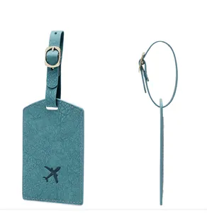 Detailed view of teal PU leather luggage tag with aircraft icon and metal buckle texture