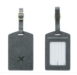 Detail of grey PU leather luggage tags with aircraft icon and contact info card
