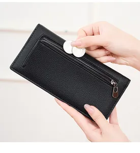 Detail of RFID long wallet showing coins being placed into a silver zipper pocket