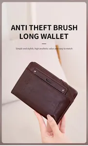 Detail of RFID blocking brown leather passport holder with elastic strap and engraving