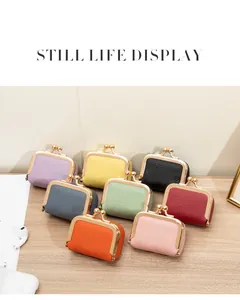 Mini pochettes à monnaie en cuir grainé présentées en huit couleurs sur une table