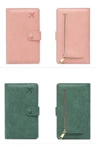 Front and back detail of litchi texture RFID travel wallets in pink and dark green colors