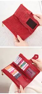 Close-up of red leather wallet interior showing multiple card slots and zip pocket