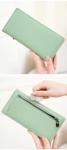 Detail of mint green pebble leather wallet with a metal zipper coin pocket on the back